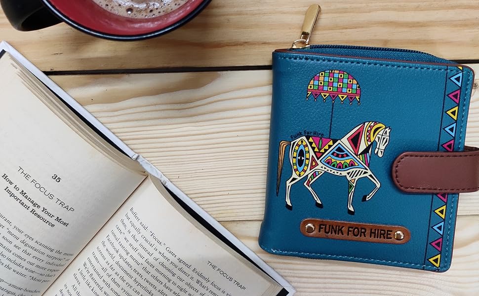 Horse Printed Loop wallet on desk along with a cup of coffee and a book